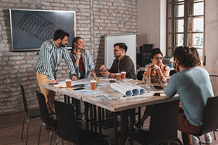 Group Of Modern Business People Discussing Architectural Designs