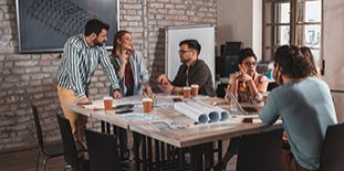 Group Of Modern Business People Discussing Architectural Designs
