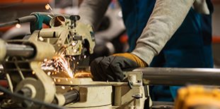 Worker Working With A Circular Grinder On A Metal With Sparks